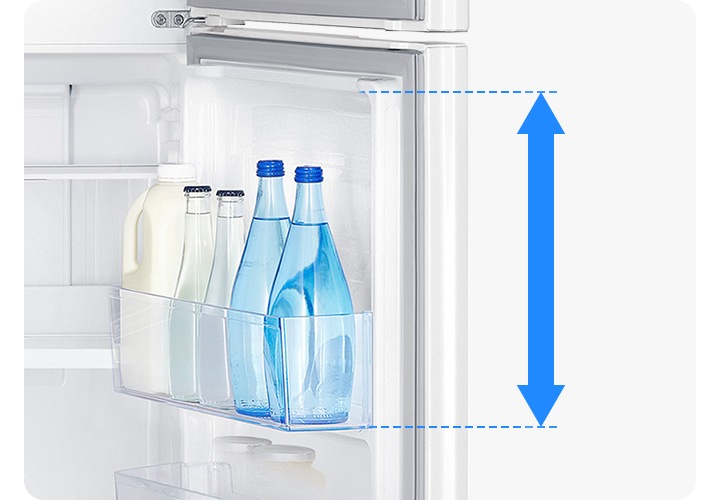 냉장실 도어 부분에 큰 우유병과 물병 등 길이가 긴 음료가 들어있습니다. 제일 우측에 있는 긴 파란색 물병 우측에 빅가드의 길이만큼 하늘색 화살표로 강조하고 있는 이미지입니다.