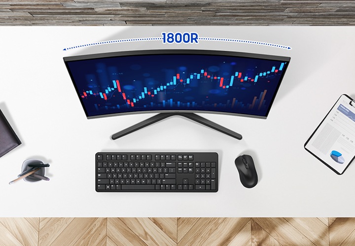 책상을 위에서 내려다보는 모습이고, 책상 위에는 수첩 연필꽂이, 키보드, 마우스, 파일이 올려져 있습니다. 모니터 화면에는 주식 그래프가 보입니다.