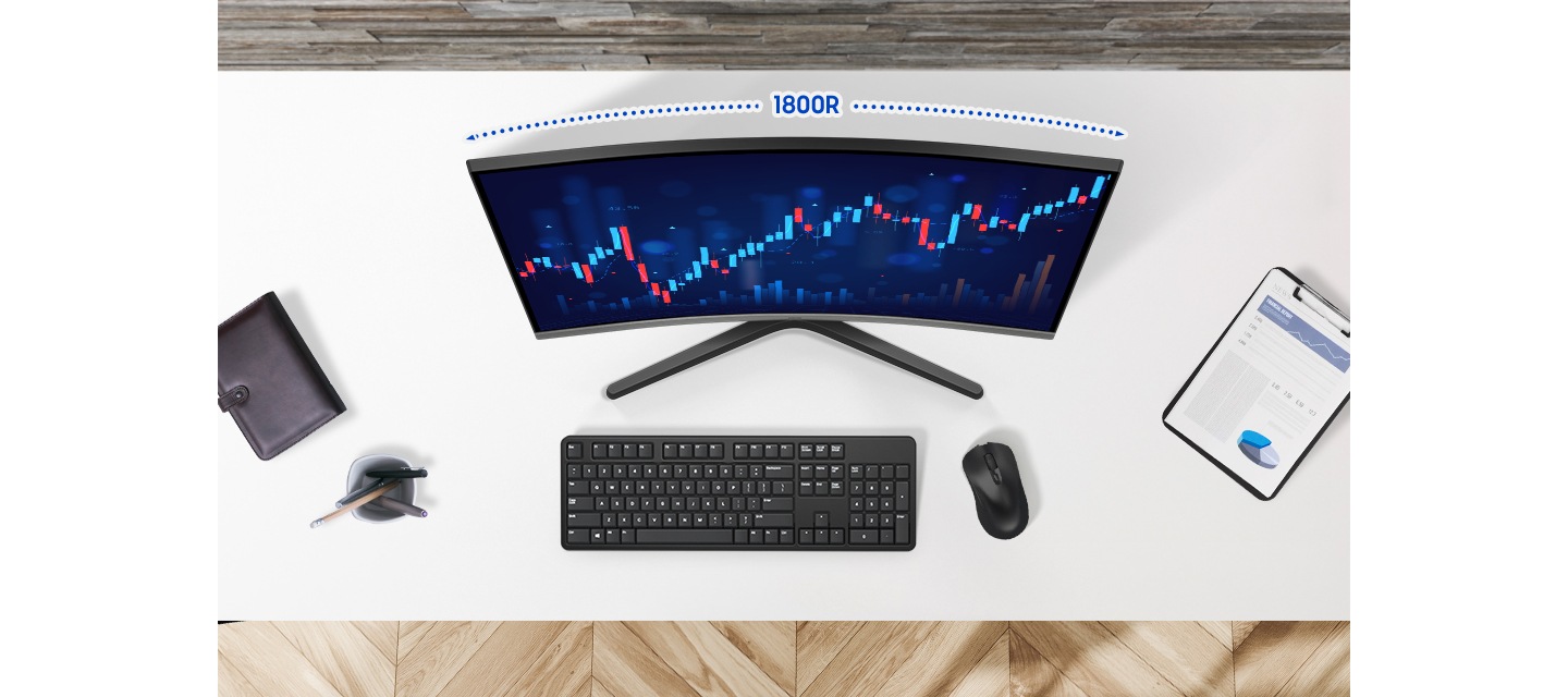 책상을 위에서 내려다보는 모습이고, 책상 위에는 수첩 연필꽂이, 키보드, 마우스, 파일이 올려져 있습니다. 모니터 화면에는 주식 그래프가 보입니다.