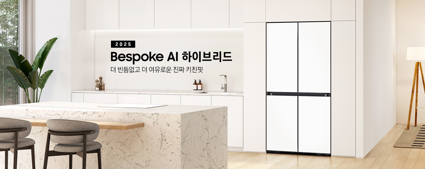 2025 Bespoke AI 하이브리드. 더 빈틈없고 더 여유로운 진짜 키친핏. 화이트톤의 주방 인테리어컷으로 냉장고장에 4도어 냉장고가 설치되어 있습니다. 냉장고 좌측으로는 동일한 화이트톤 상하부장과 수전, 오브제가 나와있으며 우측으로는 스탠드 조명이 나와있고 앞쪽에는 대리석 아일랜드 식탁이 나와있는 이미지 입니다.