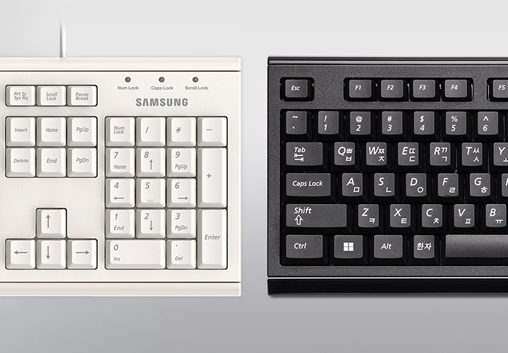 흰색의 키보드와 검은색의 키보드가 나란히 놓여있습니다.