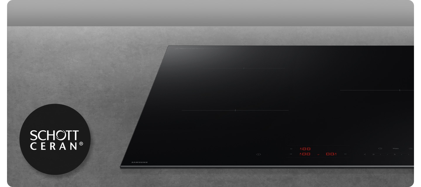 진한 회색의 대리석을 배경으로 이미지 오른쪾 부분에는 인덕션의 정면 이미지가  약간 잘려서 보이고 있고 이미지 왼쪽 부분에는 SCHOTT CREAN ® 로고가 보이고 있습니다.