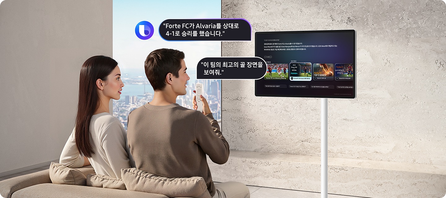 여성과 남성이 소파에 앉아 있으며 남성이 리모컨으로 The Movingstyle에 Forte FC의 최고의 골 장면을 보여달라고 요청하고 있습니다. The Movingstyle은 GZN News에서 제공하고 있는 하이라이트 영상도 지금 확인 가능하다고 안내하고 있습니다.