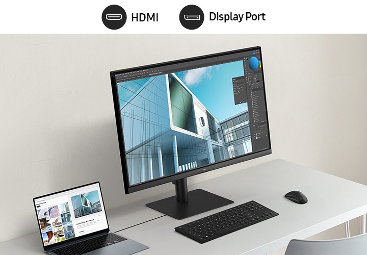 데스크에 작업중인 모니터와 노트북, 키보드, 마우스, 스마트폰이 놓여져 있습니다. 모니터 화면에는 포토샵을 이용하여 디자인 작업중인 모습이 보입니다. 