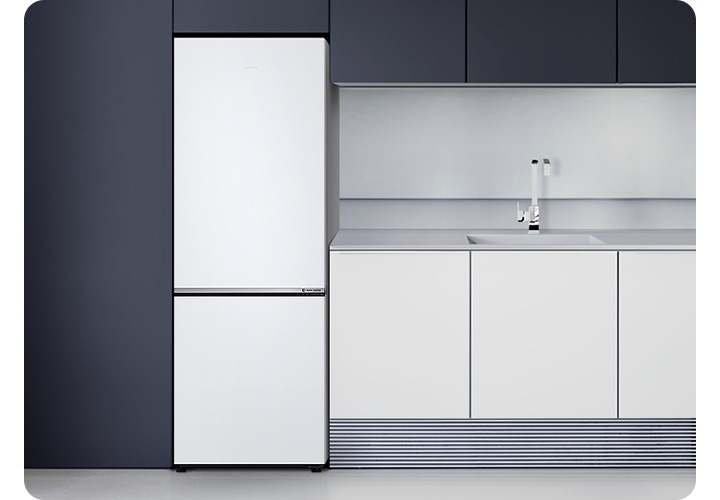 어두운 블랙톤 냉장고장에 냉장고가 설치되어 있고 우측에 밝은 그레이톤 하부장이 설치되어 있습니다.