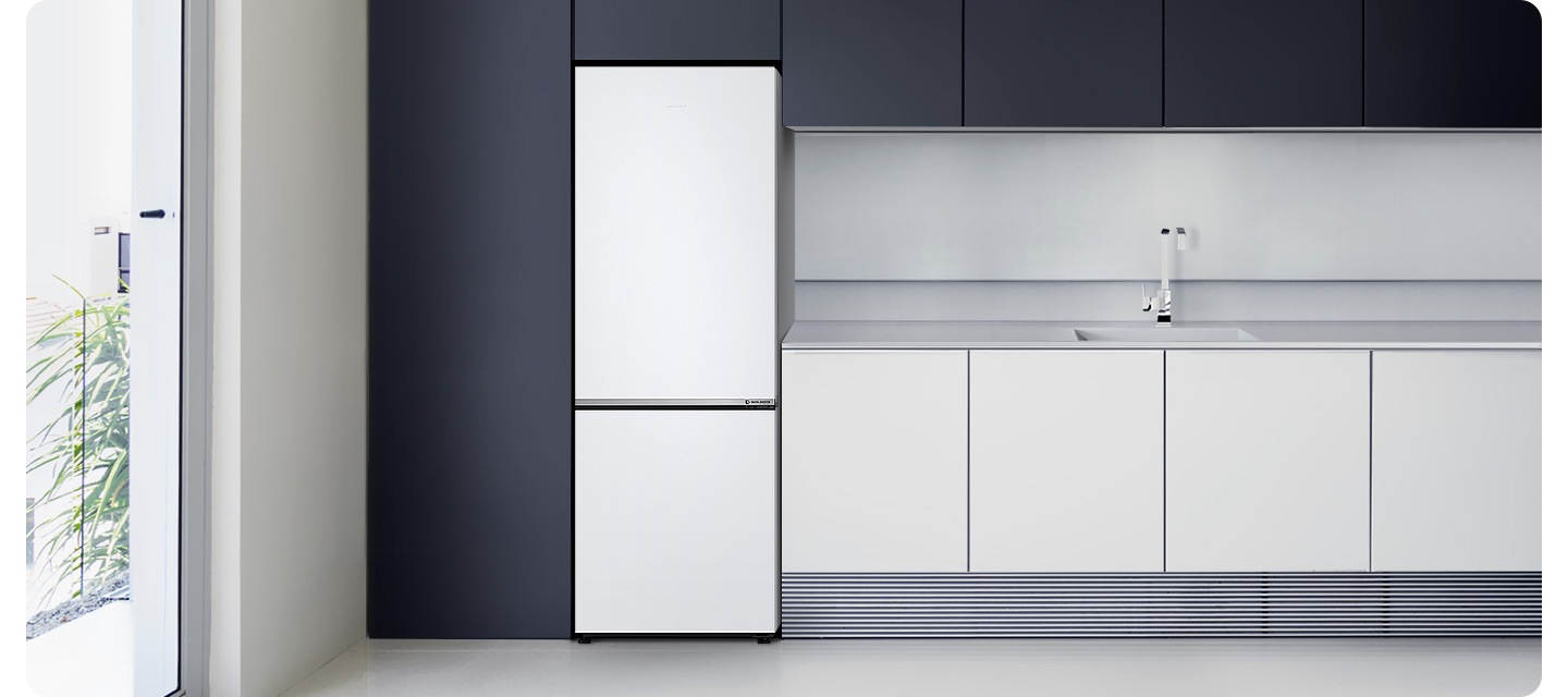 어두운 블랙톤 냉장고장에 냉장고가 설치되어 있고 우측에 밝은 그레이톤 하부장이 설치되어 있습니다.