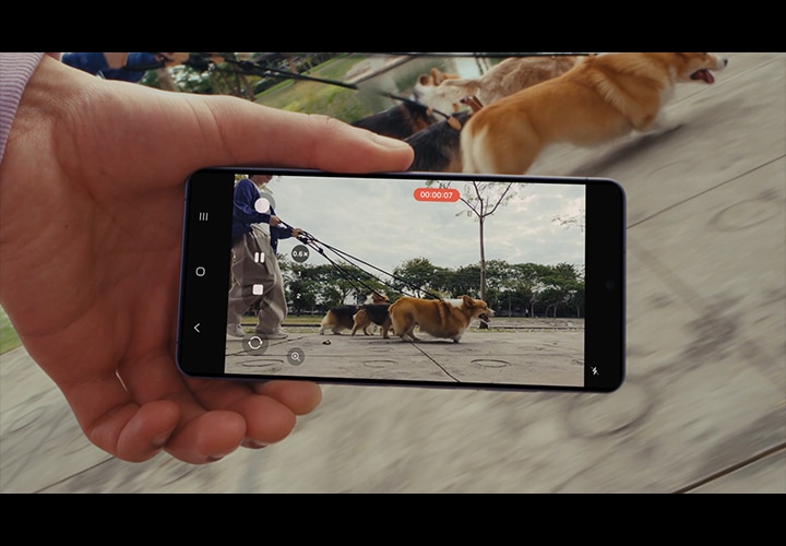 갤럭시 S26 시리즈로 영상을 촬영하려고 합니다. 사용자가 슈퍼 스테디에서 수평 고정 아이콘을 누른 다음 녹화 버튼을 누릅니다. 그 다음, 기기를 들고 달리는 뒷모습이 나타납니다. 그런 다음, 화면에 사용자가 반려 동물의 달리는 모습을 촬영하는 장면이 나타납니다. 둘 다 달리고 있지만 영상은 흔들림 없이 안정적으로 유지됩니다.