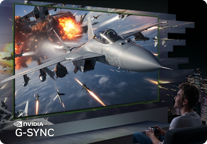 남성이 게임을 하고 있습니다. TV 화면에서는 우주선이 TV 밖으로 나오는 듯한 모습이 보입니다.