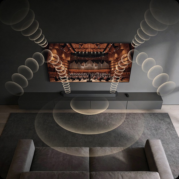 벽에 TV가 설치되어 있습니다. TV 아래에는 사운드바가 설치된 장식장이 있습니다. TV와 사운드바에서 음향효과가 나옵니다.