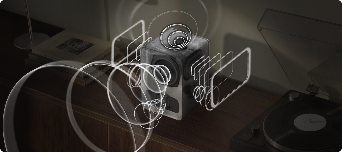 장식장 위에 스피커가 놓여 잇습니다. 스피커 오른쪽에는 턴테이블이 놓여 있고, 왼쪽에는 책들이 놓여 있습니다. 스피커에서는 음향효과가 나오고 있습니다.