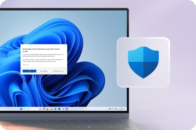 푸른색의 Windows 11 배경 화면이 표시된 노트북 화면에 보안 관련 팝업 알림창이 나타나 있으며, 오른쪽에는 파란색 방패 모양의 보안 아이콘