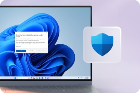 푸른색의 Windows 11 배경 화면이 표시된 노트북 화면에 보안 관련 팝업 알림창이 나타나 있으며, 오른쪽에는 파란색 방패 모양의 보안 아이콘