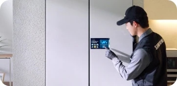 냉장고를 수리하고 있는 기사