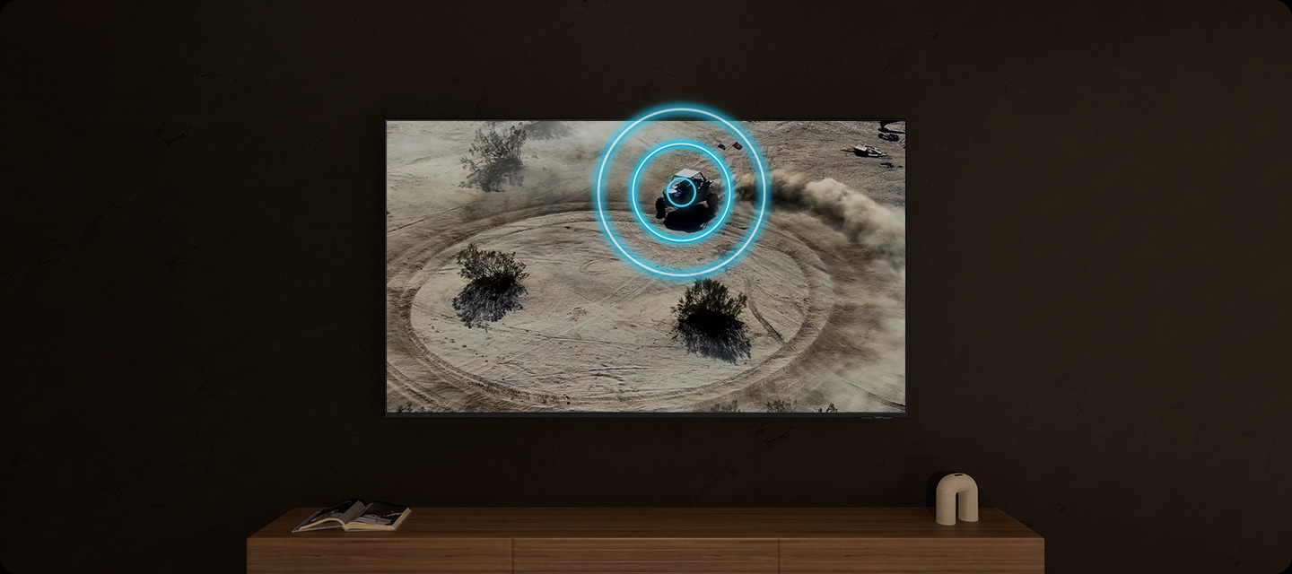 TV 화면에는 사막에서 원을 그리며 오토바이를 타고 움직이는 사람이 있습니다. 오토바이가 움직이는 방향에 따라 먼지가 발생하고 있습니다.