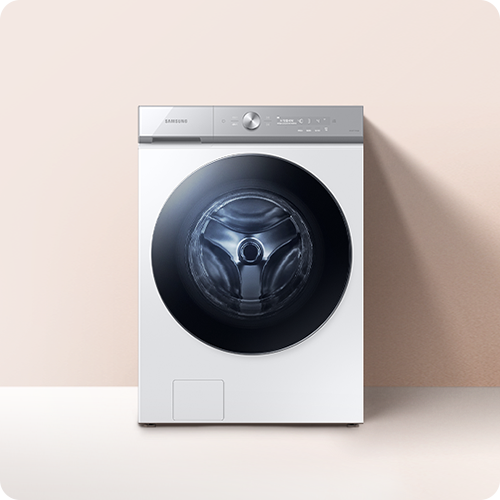 엷은 분홍색 벽과 흰 바닥으로 된 공간입니다. 엷은 분홍색 벽 중간 앞에 세탁기가 있는 이미지입니다.