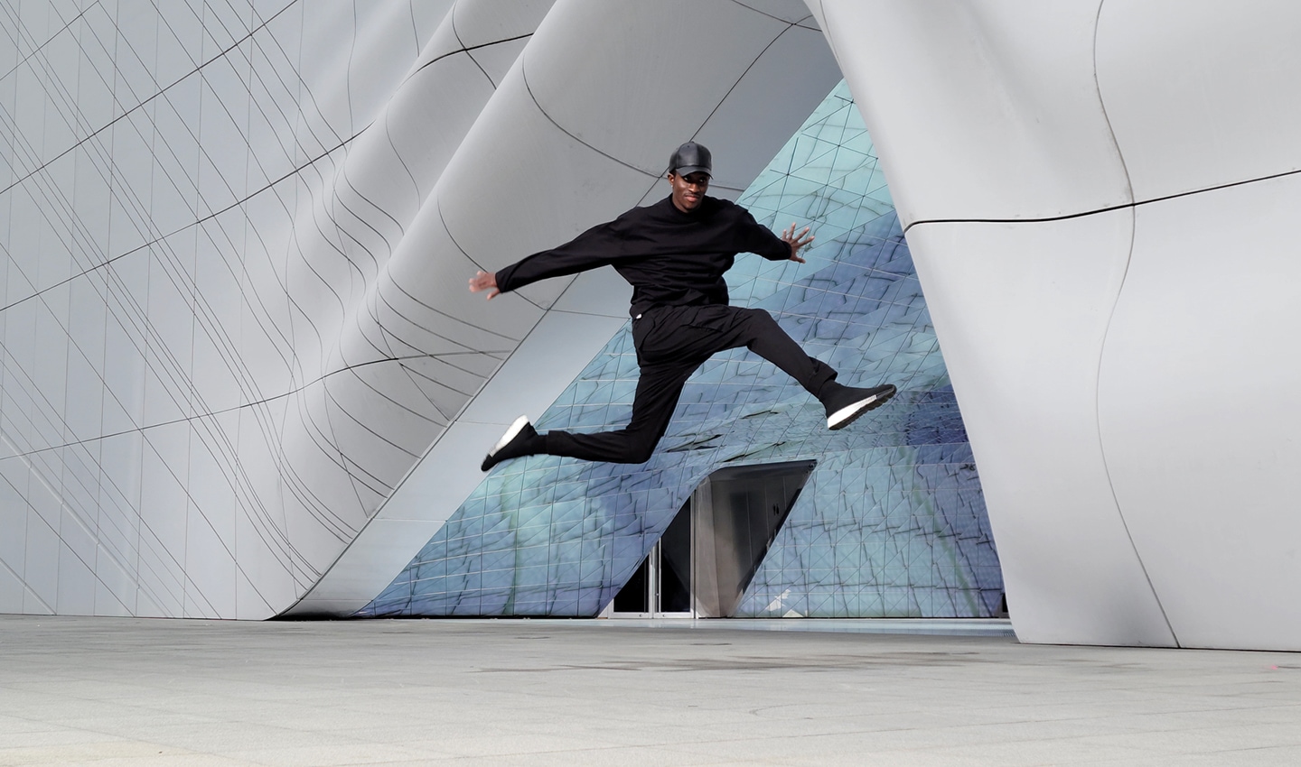 Scene of a man dancing in front of an architectural structure, shot with 8K on Galaxy S21 Ultra 5G. A still image is taken from the video using 8K Video Snap. The image shows how crisp a frame from 8K video looks as a photo.