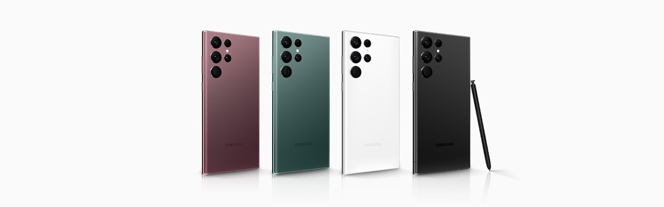 Four Galaxy S22 Ultra’s stand in one row with their rear sides facing forward, as they all face right at an angle, with the furtherest right device having an S Pen lean against it. From left to right, the colors go: Burgundy, Green, Phantom White and Phantom Black.