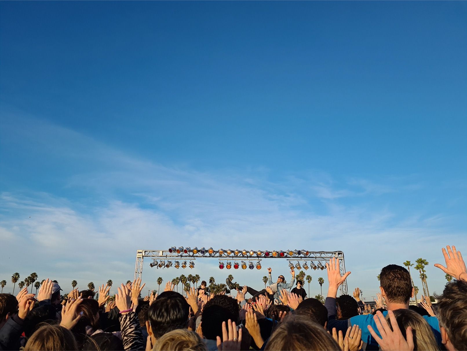 Photo taken on Galaxy S20 plus near the back of a crowd at an outdoors concert. As we zoom in on the photo, we see a funny moment of a man crowdsurfing near the stage, showing how Space Zoom lets you find moments you might have otherwise missed