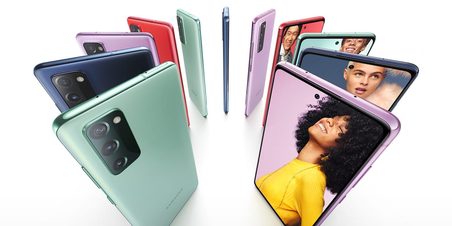 Eleven Galaxy S20 FE phones standing upright in a circle, alternating Cloud Navy, Cloud Red, Cloud Lavender, and Cloud Mint. Some are seen from the rear and some are seen from the front, with photos of people onscreen. Each person stands against a color background that matches the color of the phone.