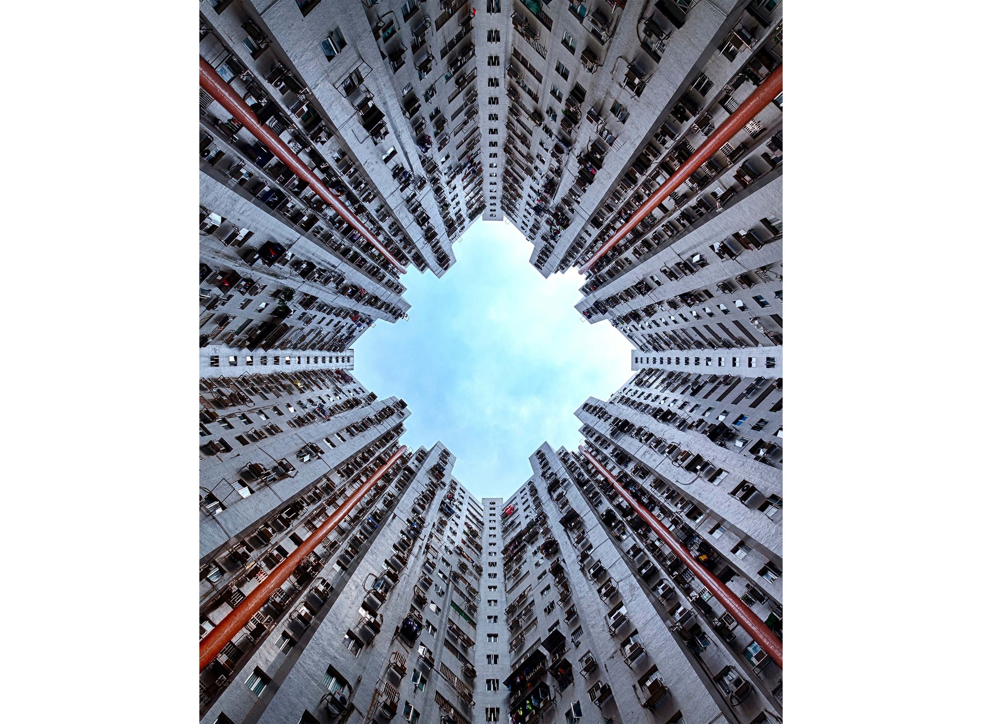 Skyscrapers, with the camera looking up towards the tops of the buildings at the blue sky in the center seen on the Cover Screen.