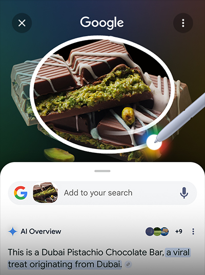 S Pen incercuieste ciocolata Dubai. Bara de cautare Google este afisata dedesubt, cu prezentarea generala a rezultatelor AI.