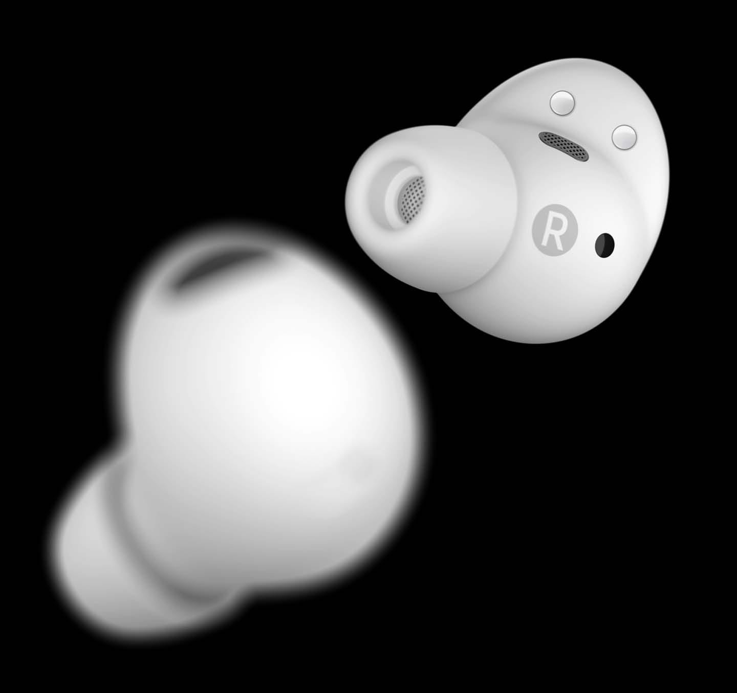 Two white Galaxy Buds2 Pro earbuds paced one in front of the other using a short depth of field. The left ear bud is placed closer and appears blurry. The right ear bud is farther away and appears clear.