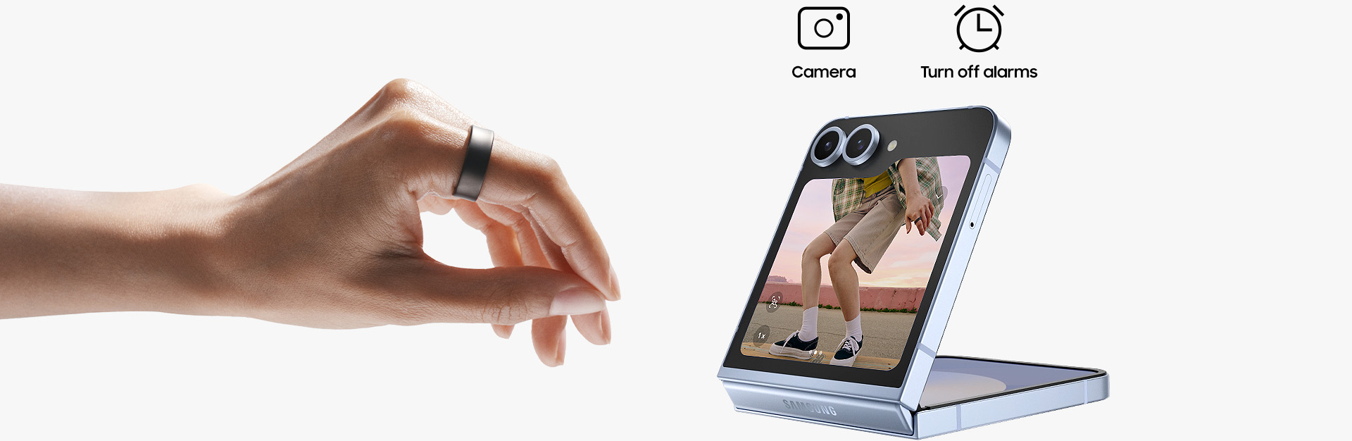 A hand wearing Galaxy Ring can be seen, making a pinching motion. A closed Galaxy Z Flip6 with the camera open on the cover screen can be seen. Above the smartphone are two icons: Camera and Turn off alarms.