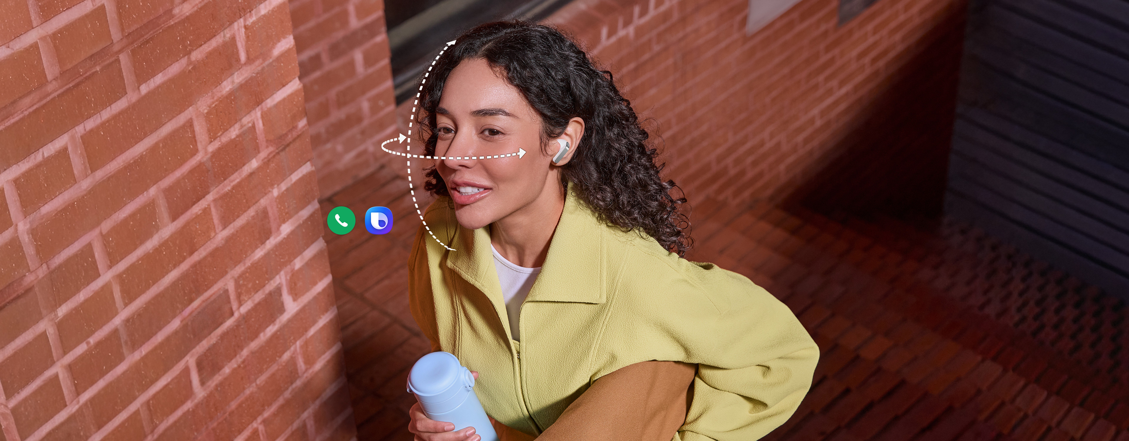 Một người đeo tai nghe Galaxy Buds4 Pro màu Trắng, một tay cầm cốc và tay kia cầm túi xách. Các đường chấm dọc và ngang uốn quanh khuôn mặt cô để thể hiện chức năng Cử chỉ Đầu, có trên Galaxy Buds4 Pro. Biểu tượng ứng dụng Cuộc gọi và biểu tượng Bixby cho thấy cả hai tính năng này đều có thể được sử dụng cho Cử chỉ Đầu.