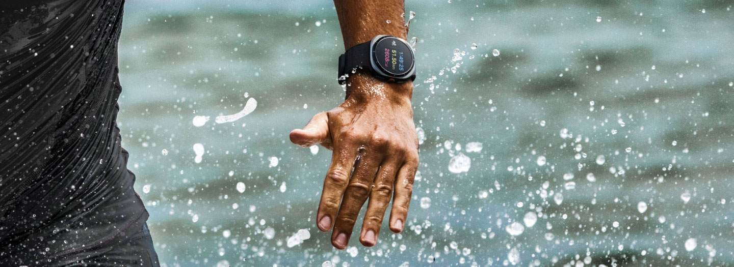 Close-up of a person coming out of the water. On the wrist is Galaxy Watch Ultra.